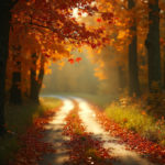 An autumn scene with vibrant colorful foliage, falling leaves, and a winding country road during golden hour.